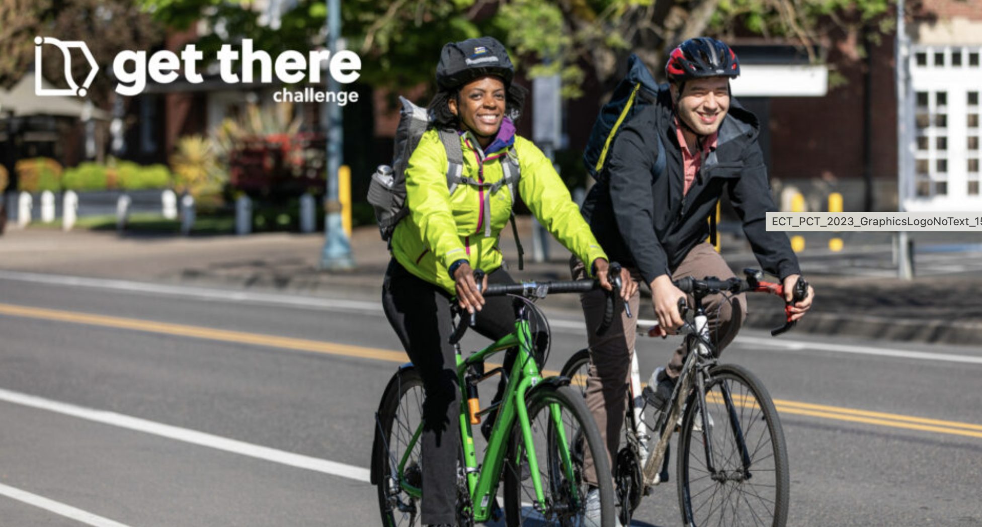 two people biking down the street